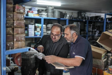 Amir (with glasses) and Abbas Agha, his colleague. Both are examining some object.