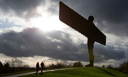 A couple walk past the Angel of the North