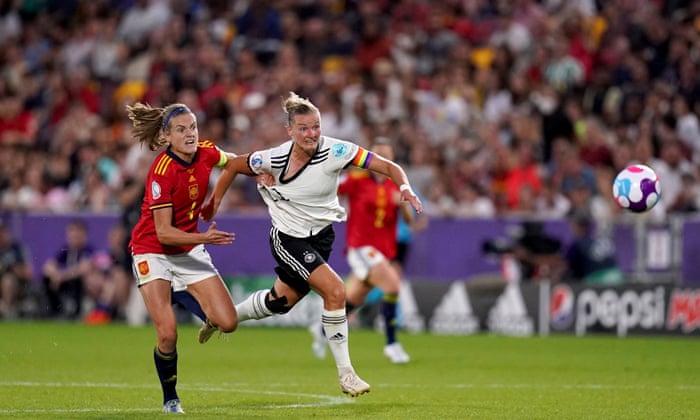 Irene Paredes grabs a good handful of Alexandra Popp's shirt as she tries to stop the German striker from unleashing towards the Spanish goal.