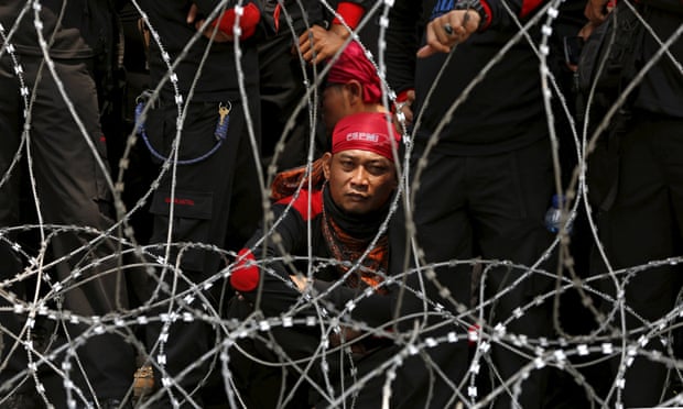 An Indonesian trade union supporter attends a protest in Jakarta over job cuts and wages.