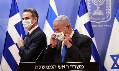 Greek prime minister Kyriakos Mitsotakis and Israel’s prime minister Benjamin Netanyahu wear face masks with both countries’ flags after a press conference on 8 February.