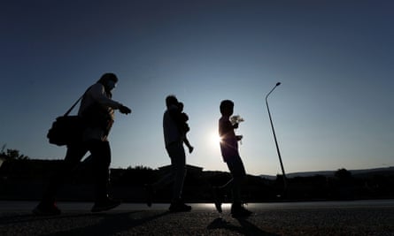 A Syrian family walks to a temporary camp for migrants and refugees on Lesbos, Greece, September 2020.