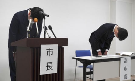 The mayor of Susono, Harukaze Murata (left), and the vice-mayor bow during a press conference in Susono, Shizuoka prefecture
