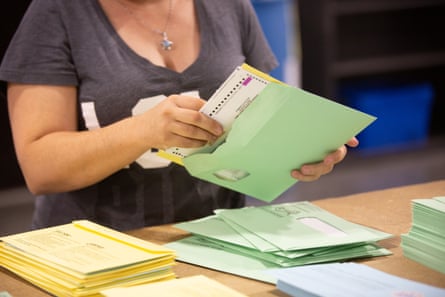 A worker verifies ballots at the Runbeck Election Services facility in Phoenix on 23 June 2020.