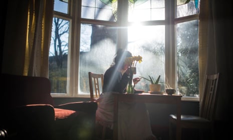 Young woman sat by a window with daffodils
