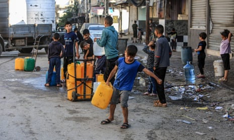 Palestinian children wait in water queues to meet their daily water needs as they live in makeshift tents under limited means and difficult conditions in Rafah, Gaza on 17 April.