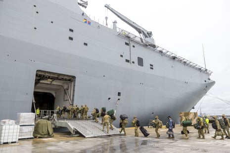 ADF soldiers load onto HMAS Adelaide Brisbane before departing for Tonga, 20 January.