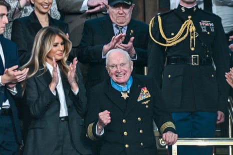 Melania Trump applauding while stood next to Capt Royce Williams.