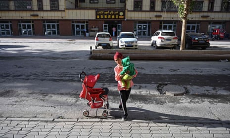 A mother in Aksu in China’s Xinjiang region, where women are being threatened with internment for refusing to abort pregnancies that exceed birth quotas.