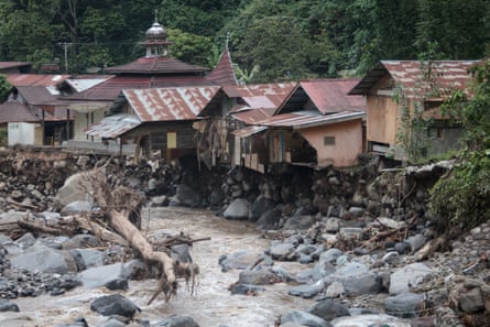 Damaged houses are seen after flash floods and cold lava flowed into the village in Tanah Datar district