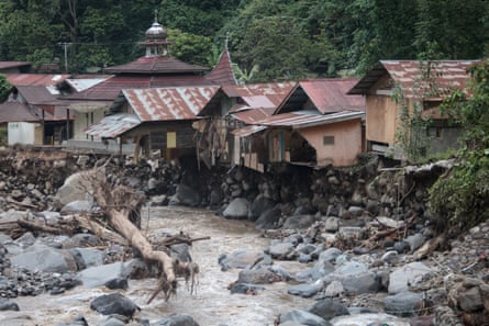 Damaged houses are seen after flash floods and cold lava flowed into the village in Tanah Datar district.