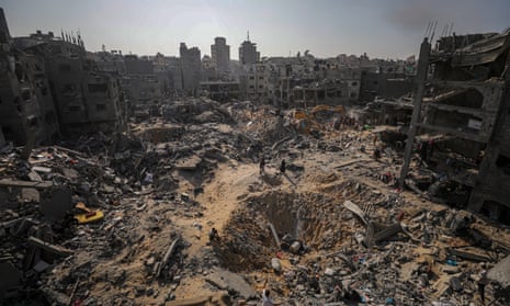 Palestinians search for bodies and survivors among the rubble of the Jabalia refugee camp.