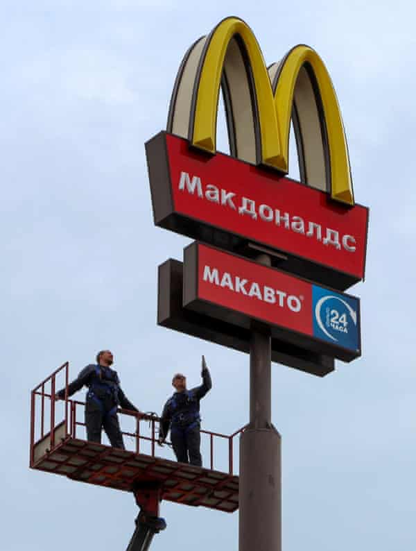 Workers use a crane to dismantle a McDonald’s ‘golden arch’ in the town of Kingisepp in the Leningrad region.