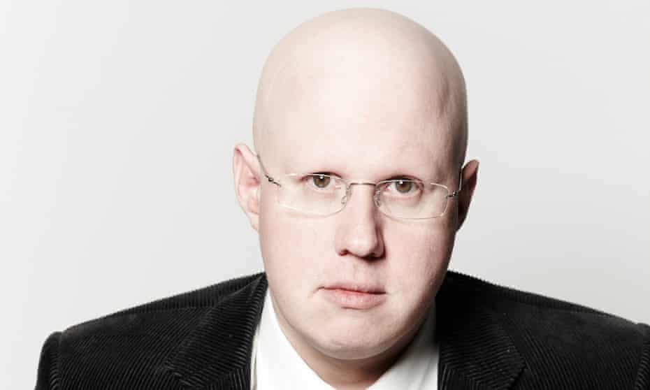 Matt Lucas, bald head, glasses, serious expression looking straight at the camera