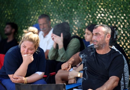 Ayten and Hayri Biçer wait for news of their two missing children outside the port of Kyrenia.