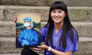 Trainee nurse Chloe Slevin, with her painting Corona Lisa showing Leonardo Da Vinci’s Mona Lisa dressed in full PPE.