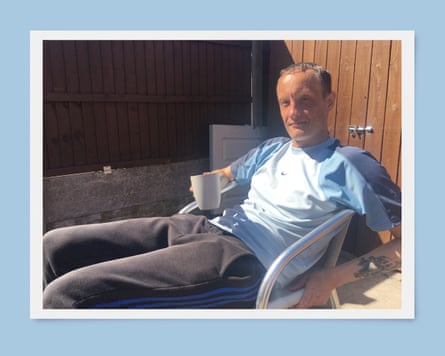 A man reclining in a chair while holding a mug
