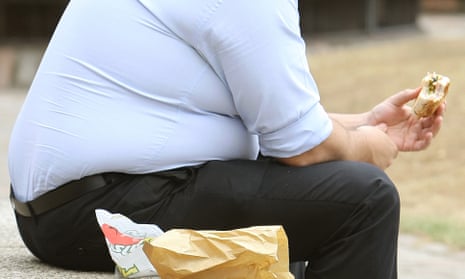 An overweight man eating.