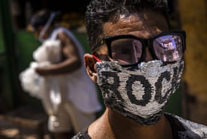 A youth wears a homemade sequinned mask
