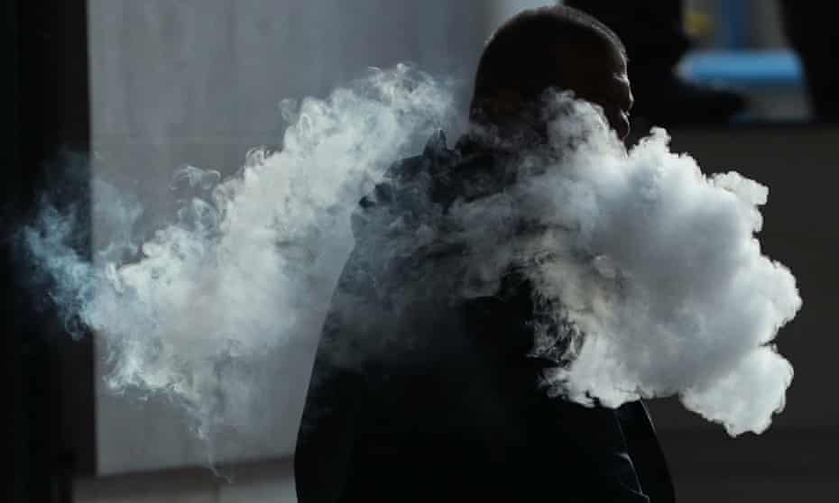 Man and vaping smoke