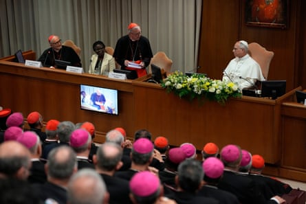 The pope listens to the Vatican secretary of state Pietro Parolin during the presentation of the encyclical