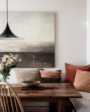 Velvet cushions around the walnut dining table.