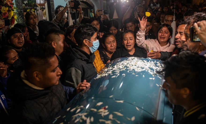 Relatives react as the bodies of Jair Valencia, Misael Olivares, and Yovani Valencia arrive to their family house in San Marcos Atexquilapan, Veracruz state, Mexico, Wednesday, July 13, 2022.