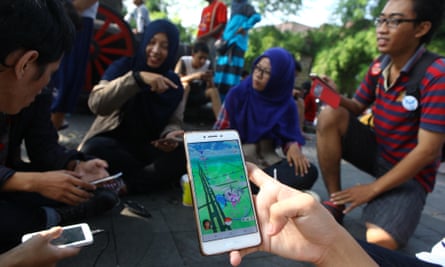 People gather to play the Pokemon Go game on their cellphones in Surakarta, Indonesia.