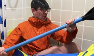 man canoeing in bath at home