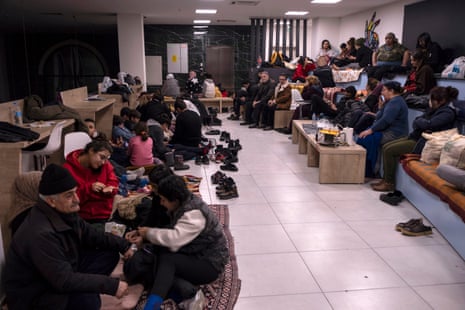 People take shelter inside a state building in Diyarbakir.