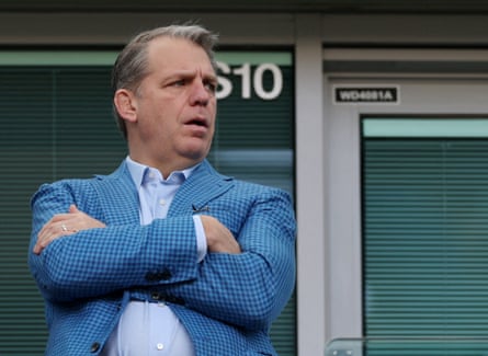 Todd Boehly stands pinch arms folded