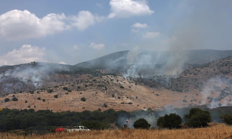 Smoke rises from fires on a hillside