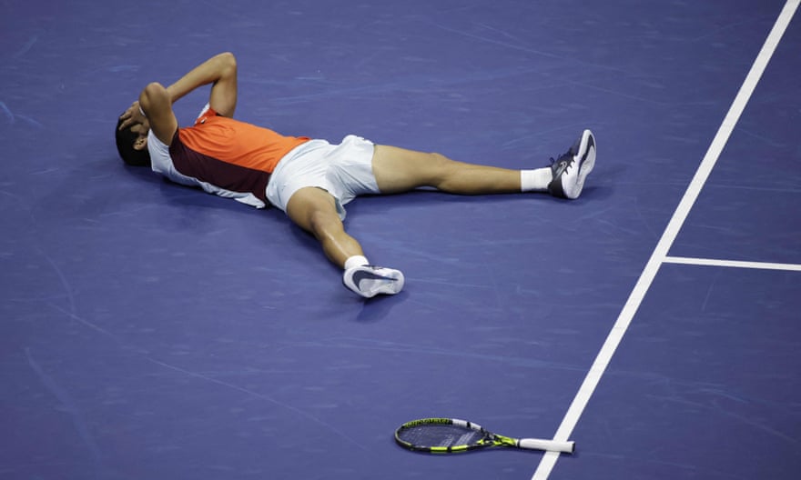 Carlos Alcaraz collapses to the floor after securing victory