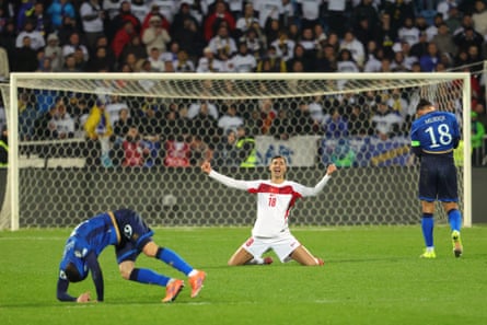 Turkey’s Mert Muldur sinks to his knees in celebration while Kosovo players show their despair.