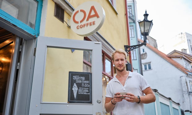 Man poses with coffee cup in hand