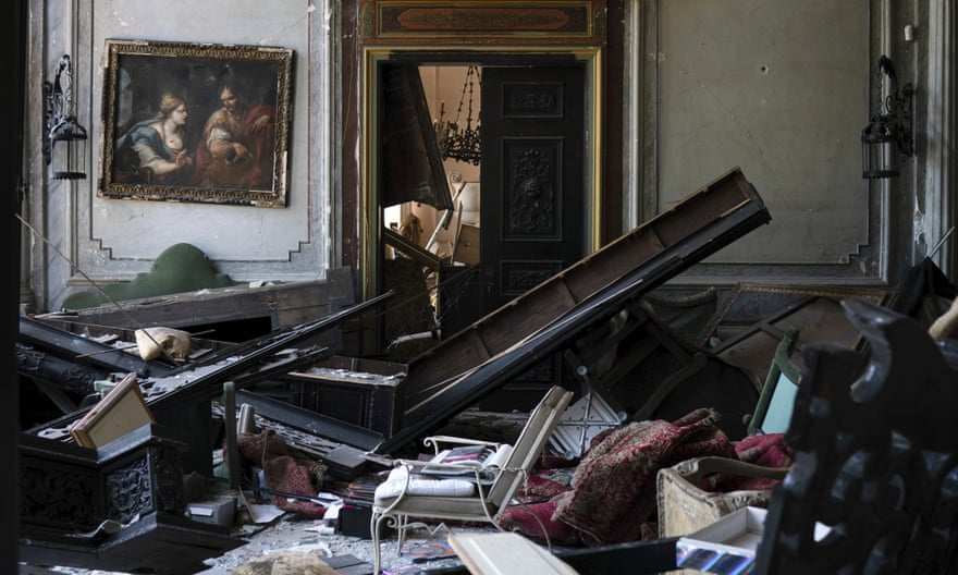 A painting hangs on the wall of a heavily damaged room in the Sursock Palace.