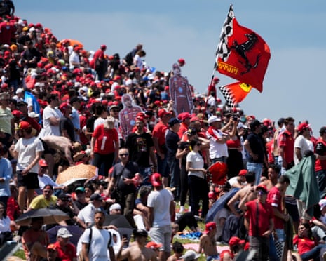 Ferrari fans wave flags during the free practice at the Enzo e Dino Ferrari Circuit, Imola.