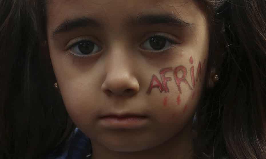 A girl with her face painted reading Afrin.