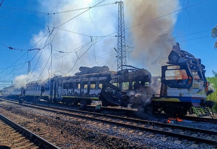 Smoke rises from the wrecked passenger train