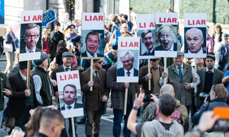 Demonstrators carry placards labelling politicians including Boris Johnson and Nigel Farage as liars.
