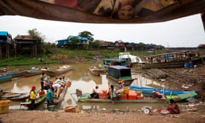 Fishermen in boats sort fish into containers on Tonlé Sap lake in Kampong Khleang, Siem Riep province, Cambodia, on 26 June 26 2015.