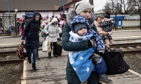 Women and children try to board an evacuation train in Irpin, Ukraine, 4 March 2022.
