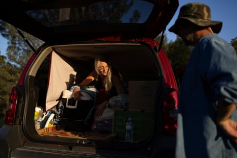 woman holds cooler in trunk