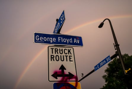 A decal pasted onto a 38th Street sign marks George Floyd Avenue.