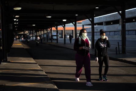 Pedestrians wearing protective masks walk near the Eastern Market in Detroit, Michigan, U.S.