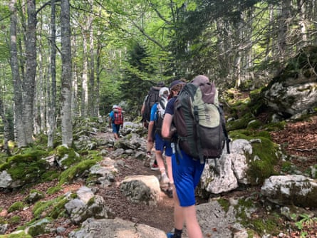 The group set off through woodland into the mountains.