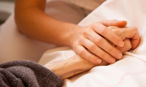 A nurse at a patient’s bedside