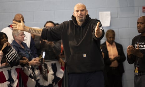 John Fetterman, a Democratic candidate for Senate, meets with supporters as he leaves his event in Philadelphia, on 24 September.