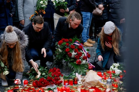 Czech Foreign Minister Jan Lipavsky and Deputy Prime Minister for Digitisation and Minister of Regional Development Ivan Bartos lay tributes at a memorial during a vigil following a shooting at one of Charles University's buildings in Prague, Czech Republic, December 22, 2023.