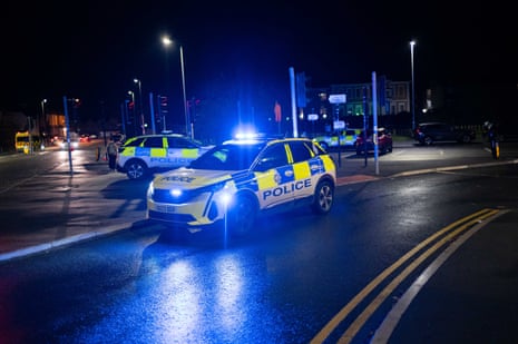 Police cars line the road near Huntingdon Station